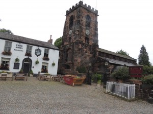 Grappenhall village, with St. Wilfred's church. Stocks formerly used for miscreants in whit fenced area right.